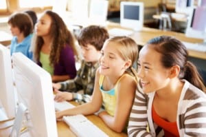 Group of children learning computer in class
