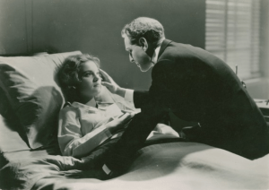 woman in hosital bed being comforted