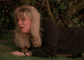 teen girl crawls on grass screaming