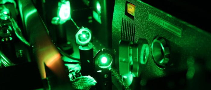 Inside the Libra: green laser light from the Evolution laser passing through lenses.